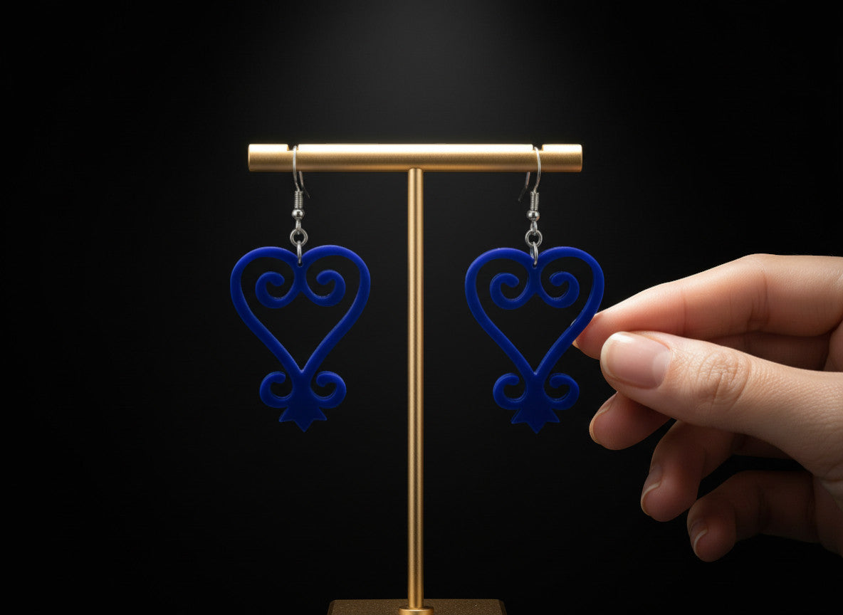 Rejecting Retail Studio blue acrylic Sankofa earrings with hypoallergenic ear wires. Handmade Afrocentric statement jewelry.