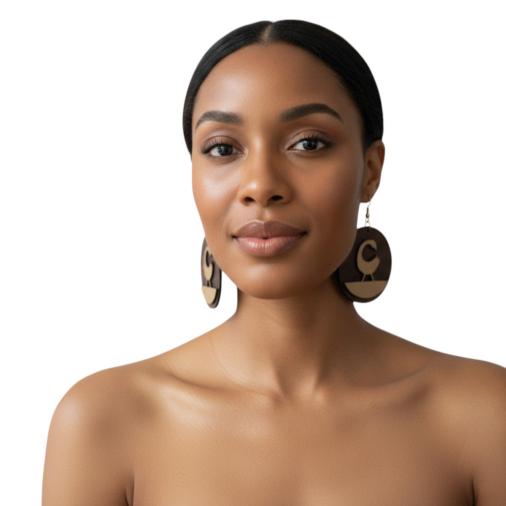 Rejecting Retail Studio walnut wood and leather Sankofa bird earrings. Large circular earrings with carved Sankofa bird motif.