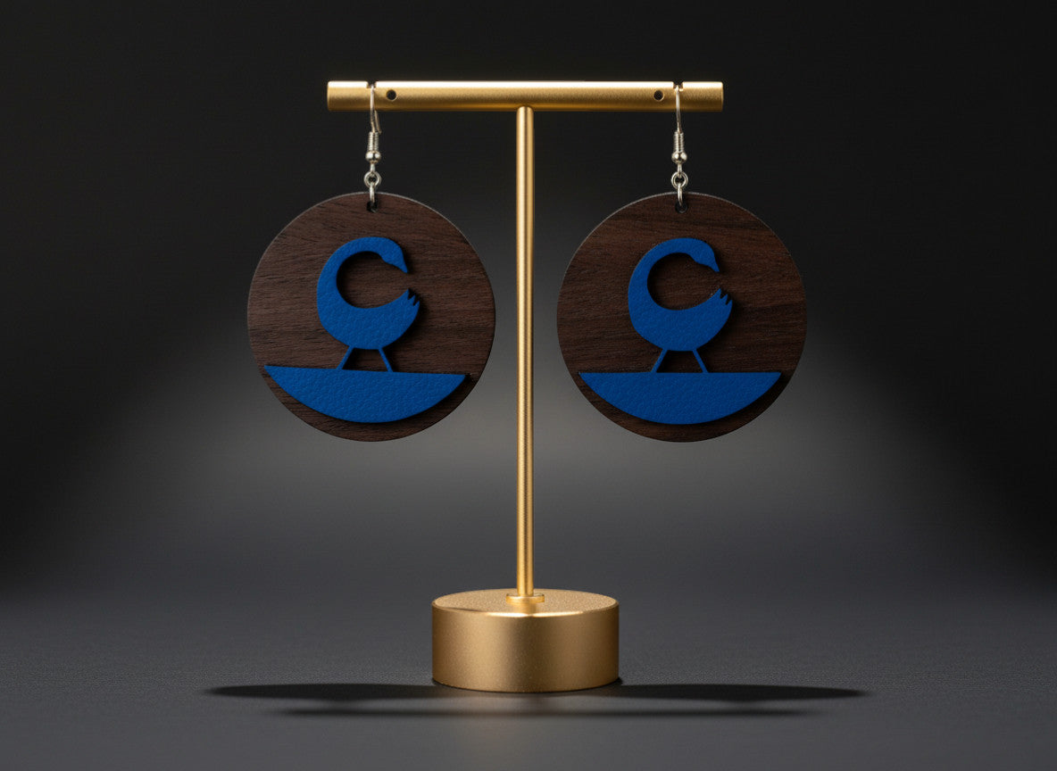 Rejecting Retail Studio walnut wood and cobalt blue leather Sankofa earrings with hook backing.