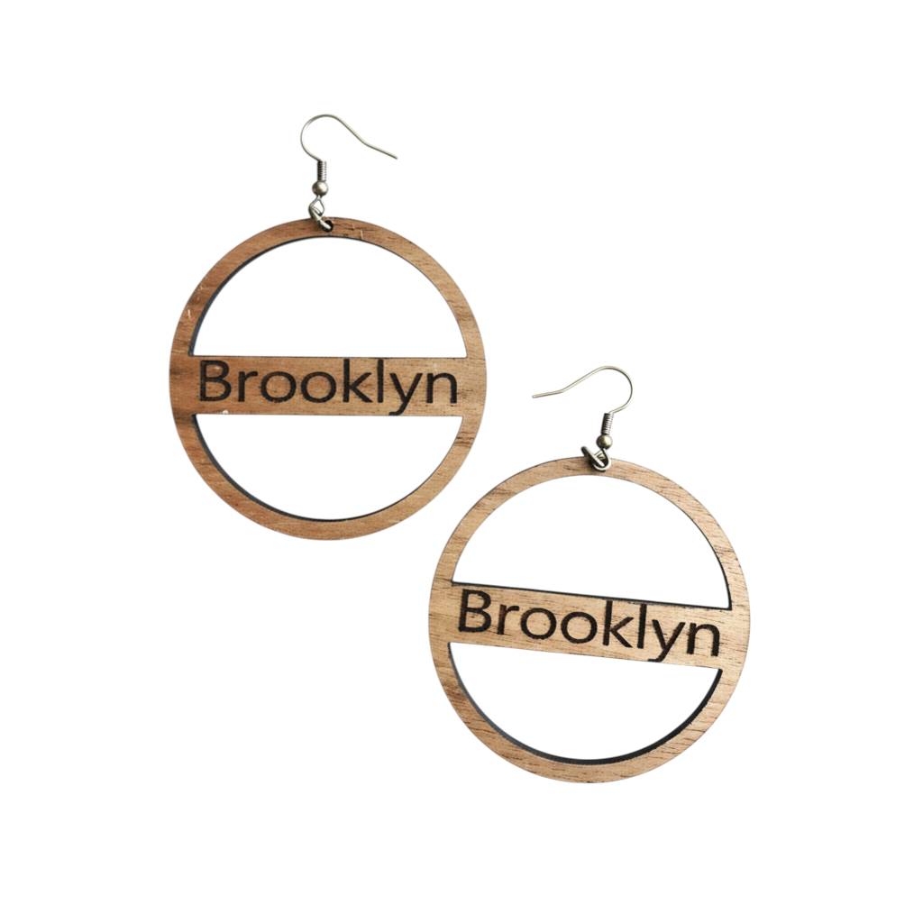 Rejecting Retail Studio natural wood hoop earrings engraved with "Brooklyn" in a vintage serif font.