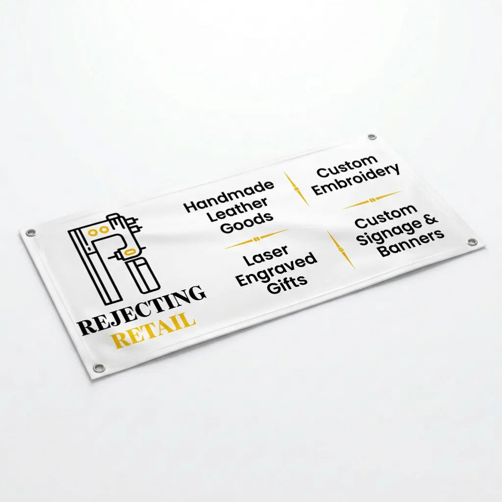 Rejecting Retail Studio custom full-color vinyl banner with services listed: Handmade Leather Goods, Laser Engraved Gifts, Custom Embroidery, Custom Signage & Banners.