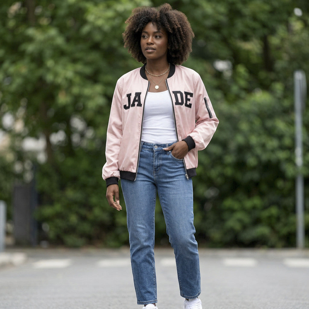 Rejecting Retail Studio pink zip-up varsity bomber jacket with black embroidered letters and trim, women's fit.