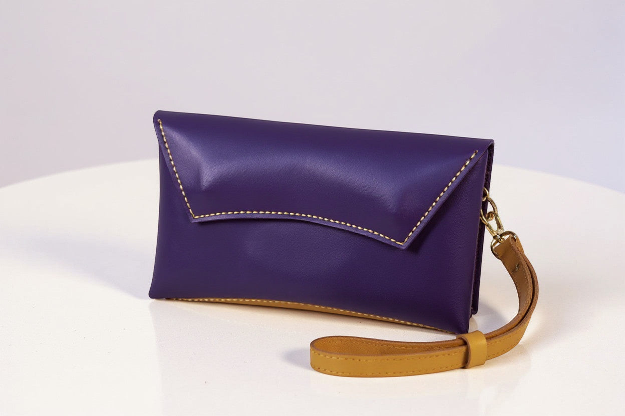 Rejecting Retail Studio handmade purple and orange leather clutch wallet with wristlet and magnetic snap closure.