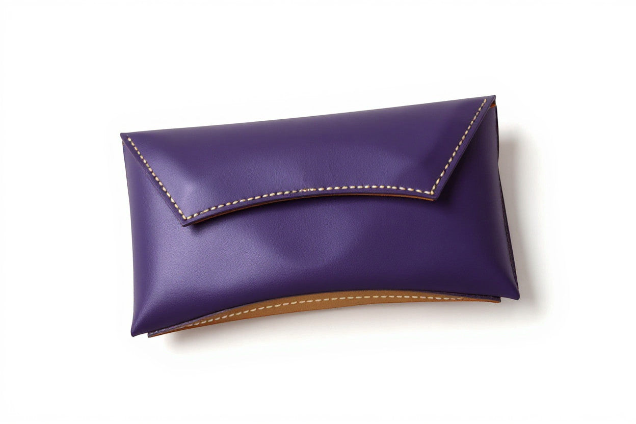 Rejecting Retail Studio handmade purple leather clutch wallet with orange trim and magnetic snap closure.