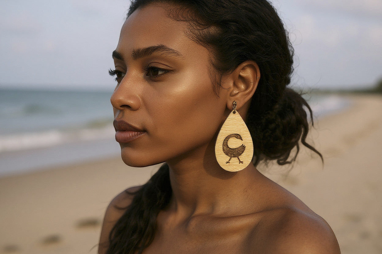 Rejecting Retail Studio Sankofa symbol laser-engraved birchwood teardrop earrings with art deco border.