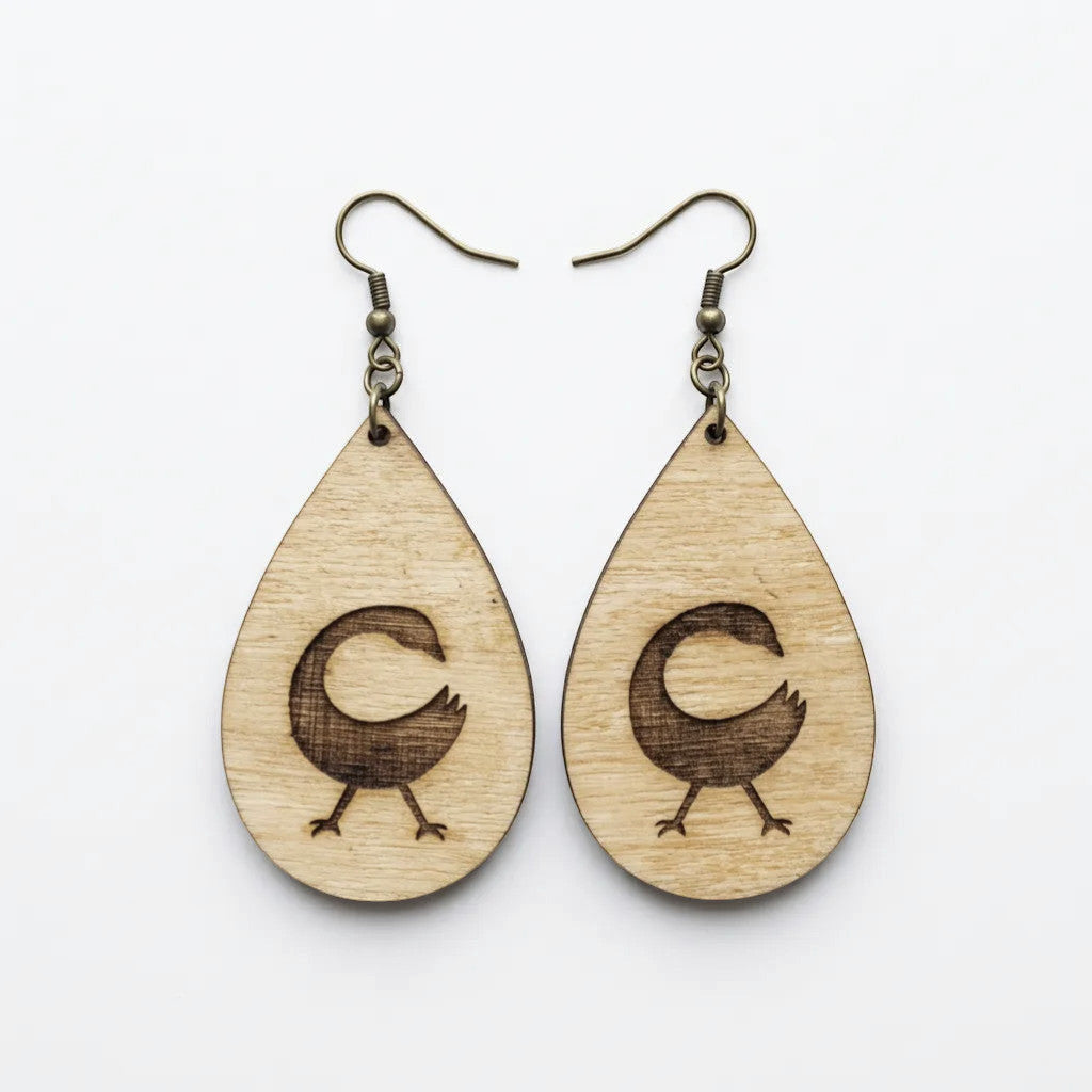 Rejecting Retail Studio Sankofa symbol engraved birchwood teardrop earrings with art deco border. Lightweight artisan jewelry.