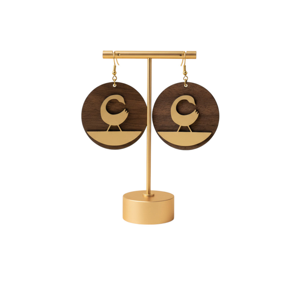 Rejecting Retail Studio walnut wood and gold Sankofa bird earrings with leather accent. Round, mixed-media design.
