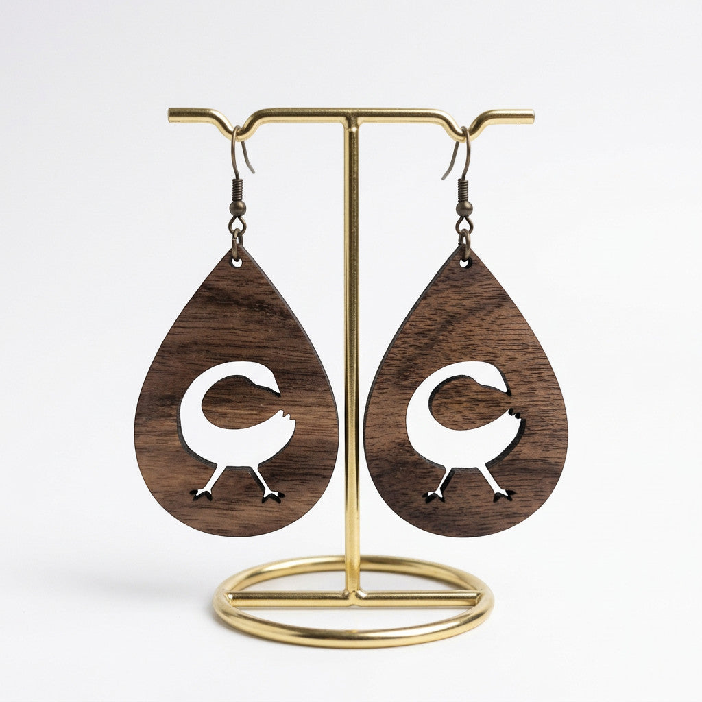 Rejecting Retail Studio Sankofa symbol laser-carved walnut wood teardrop earrings. Lightweight artisan jewelry.